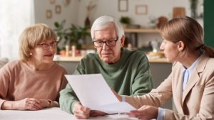 An older couple updating their will with their estate lawyer