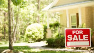 For Sale sign displayed in front of a house, representing selling a home for the first time.
