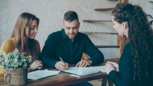Client signing legal documents with a lawyer during an estate planning consultation in Ontario.